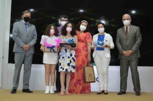 A vencedora nacional de 2021 foi a estudante Luísa Tejo Salgado Catão, de 15 anos, do 1º ano do Ensino Médio no Colégio Nossa Senhora de Lourdes, em Campina Grande (PB). O presidente dos Correios, Floriano Peixoto, e o diretor de Governança, Eduardo leal, entregaram os certificados e troféus à estudante. Foto: Site Correios